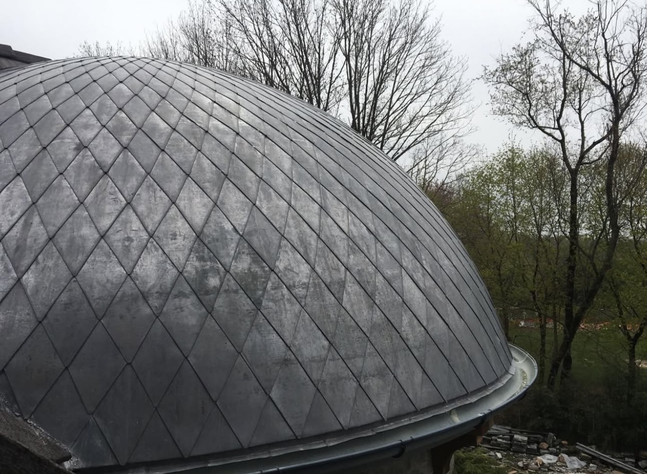 Detailed view of a custom dome roof with diamond-patterned slate tiles.